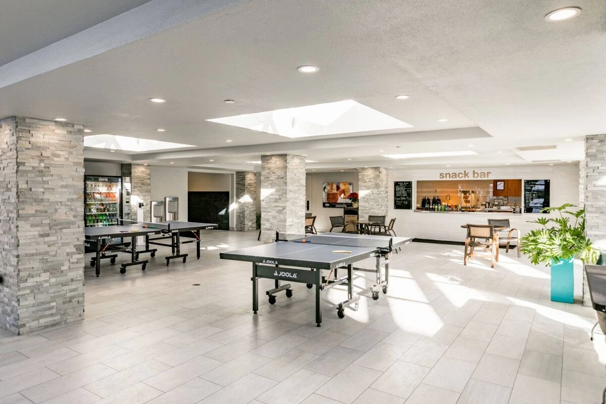 The ping pong table is located next to the indoor/outdoor pool. Lockers are available