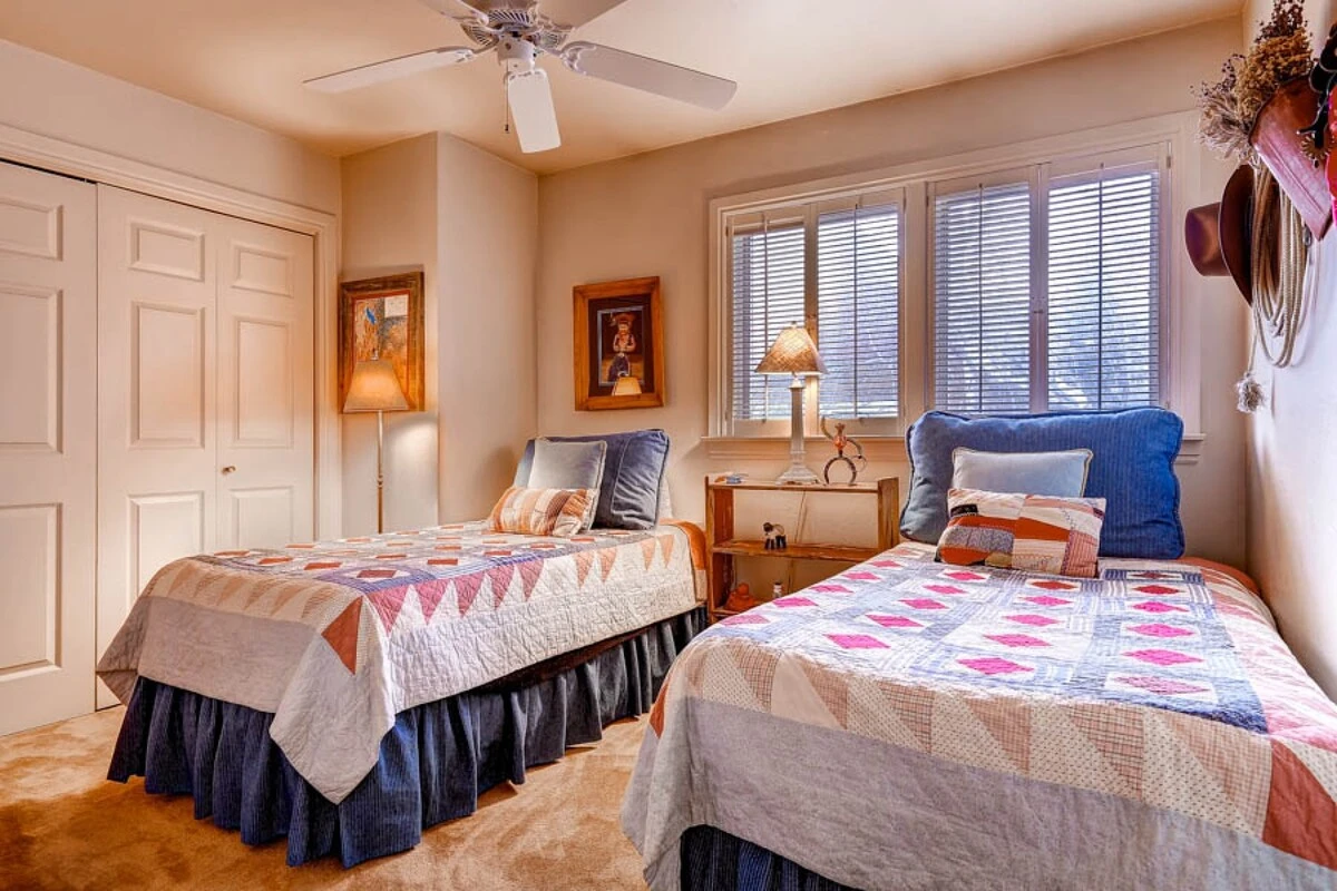 Guest Bedroom with two twin beds, closet space and bathroom.