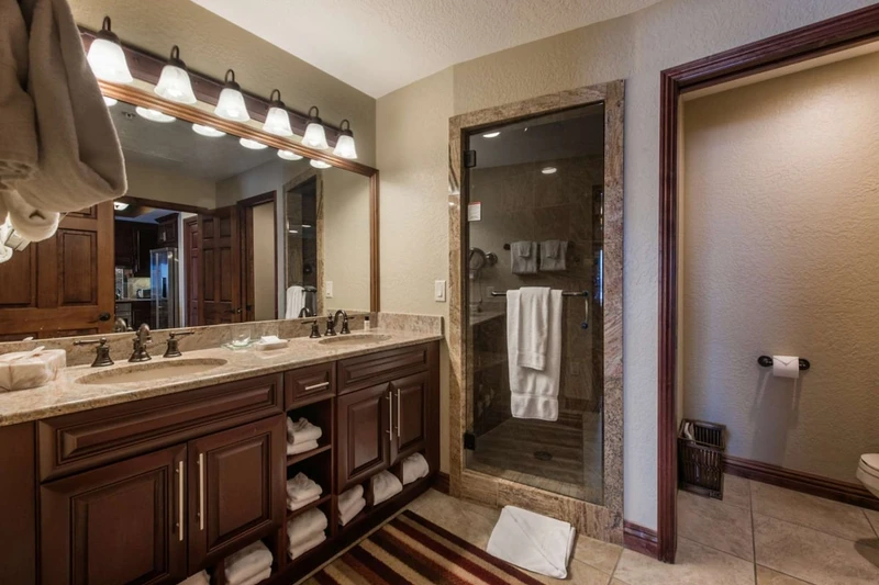 Bathroom w/ Dual Sinks, Granite countertops & Walk in Steam Shower.