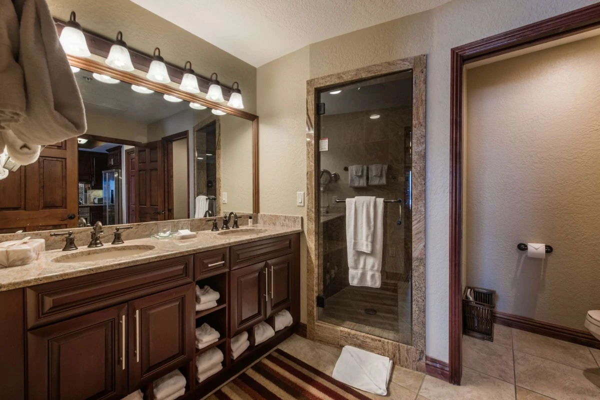 Bathroom w/ Dual Sinks, Granite countertops & Walk in Steam Shower.