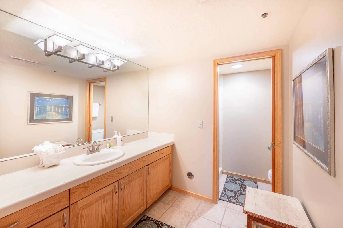 The guest bathroom features an oversized vanity with ample counter space with it's separate room for the toilet/shower it is perfect for families