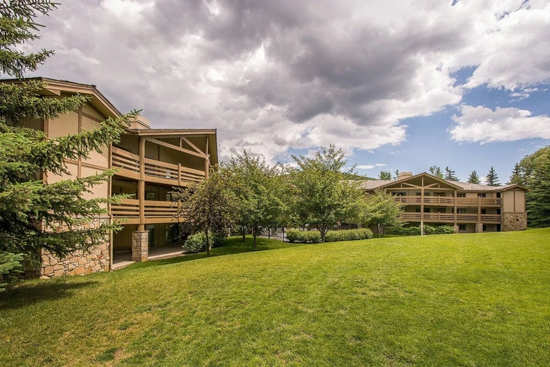 View of the home from the open green space behind the building.