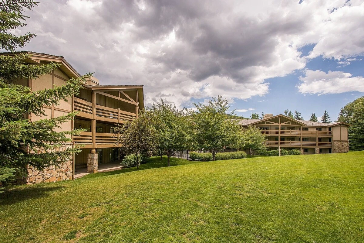 View of the home from the open green space behind the building.