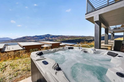 Private hot tub with lake and mountain views, seats 8