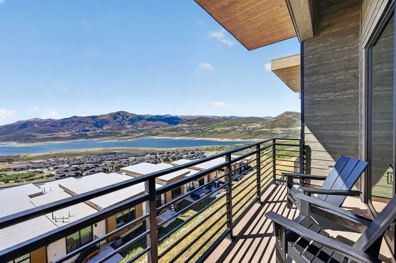 Deck off the living room with Adirondack chairs overlooking the reservoir