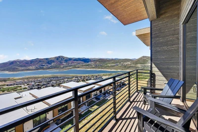 Deck off the living room with Adirondack chairs overlooking the reservoir