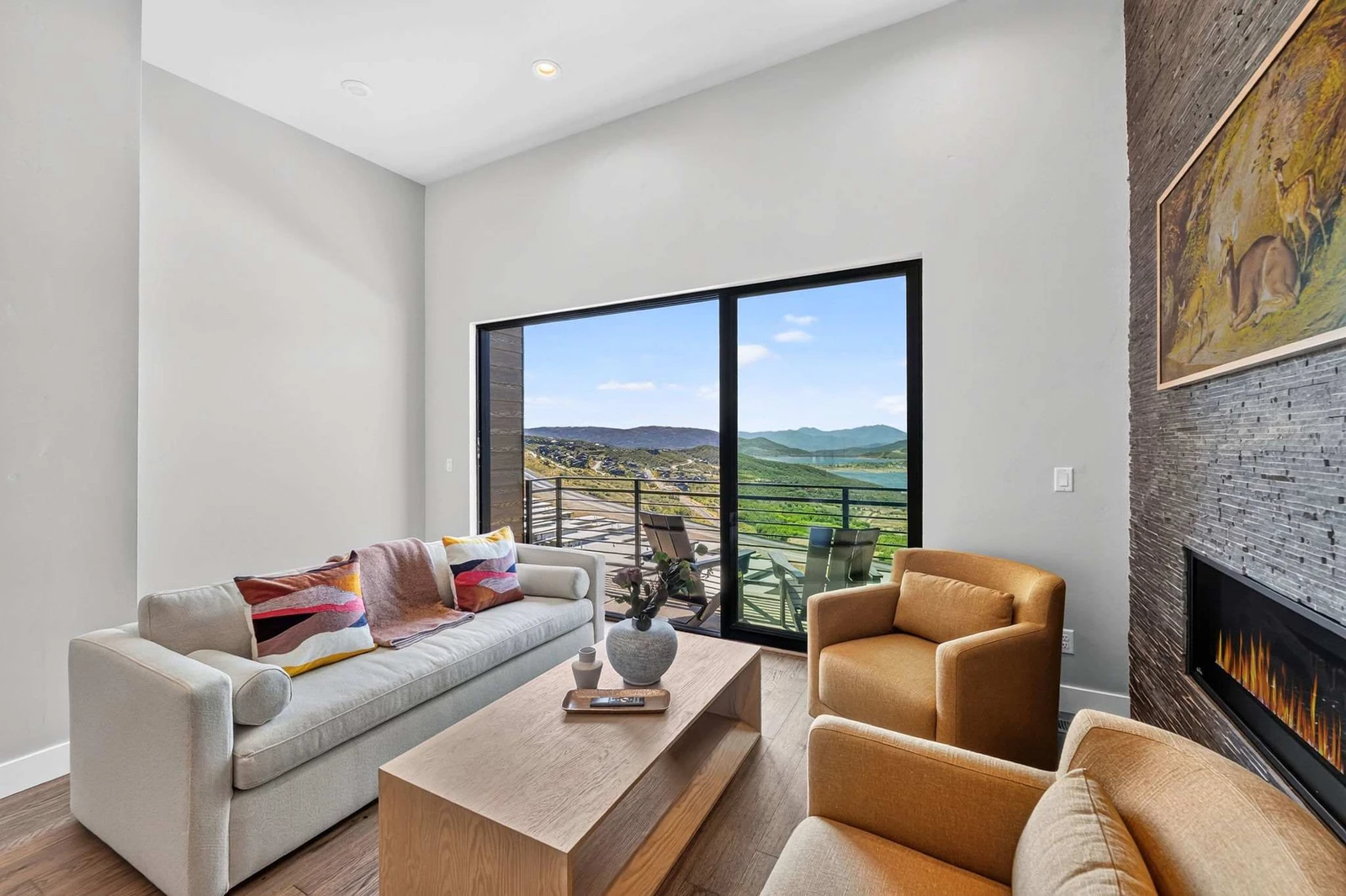 Great room with mountain and reservoir views through the sliding glass wall