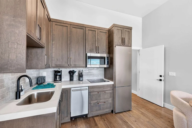 Chef’s kitchen with KitchenAid double wall ovens and stainless appliances
