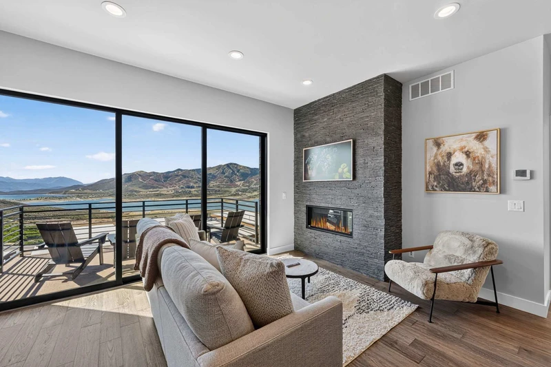 Living room with floor-to-ceiling stone fireplace and Jordanelle Reservoir views