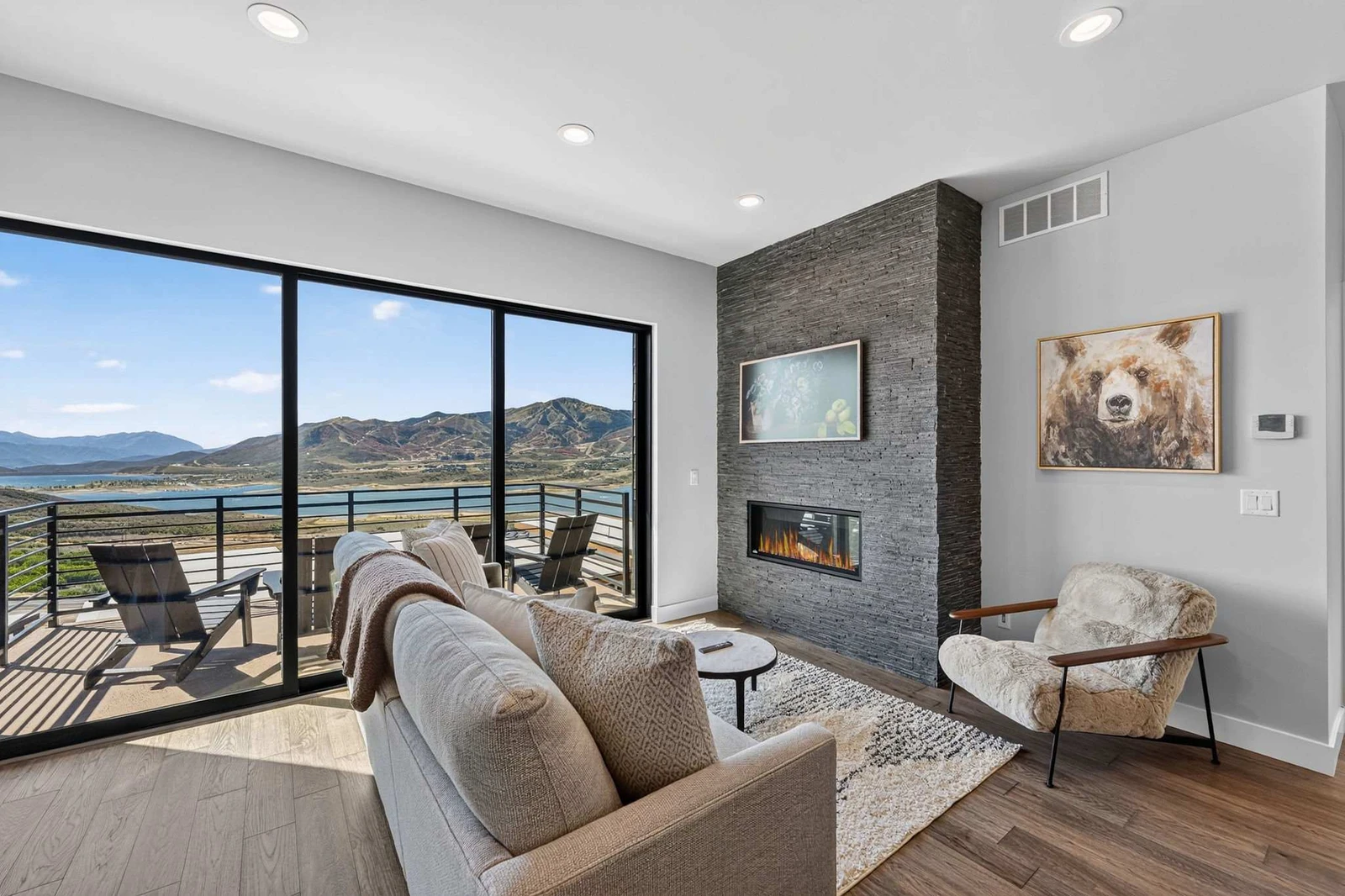 Living room with floor-to-ceiling stone fireplace and Jordanelle Reservoir views